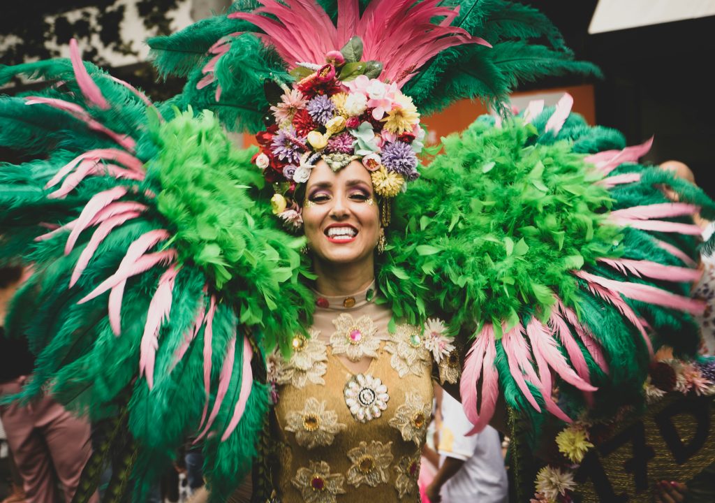 woman dressed in flowers and feathers at mardi gras celebration